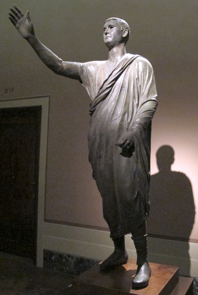 The Orator, c. 100 BC, an Etrusco-Roman bronze statue depicting Aule Metele (Latin: Aulus Metellus), an Etruscan man wearing a Roman toga while engaged in rhetoric; the statue features an inscription in the Etruscan language