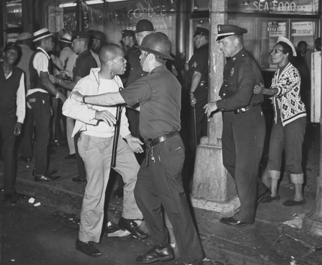 Confrontation between black protesters and police at Fulton Street and Nostrand Avenue during the 1964 riot