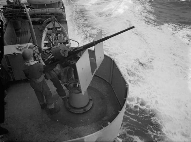 A Royal Navy Oerlikon gunner at his gun mount aboard the Dido-class cruiser HMS Dido in 1942