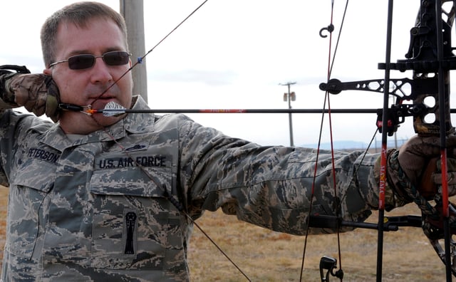Chief Master Sgt. Kevin Peterson demonstrates safe archery techniques while aiming an arrow at a target on the 28th Force Support Squadron trap and skeet range at Ellsworth Air Force Base, S.D., October 11, 2012.