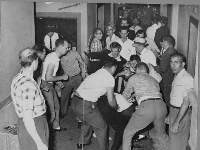 A mob beats Freedom Riders in Birmingham.