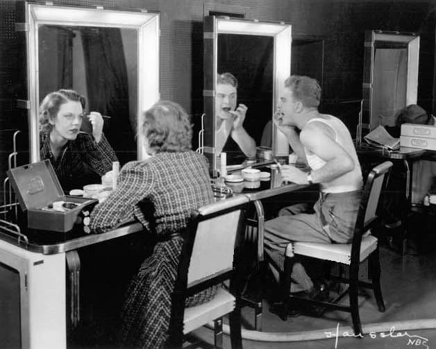 Eddie Albert and Grace Brandt apply makeup for the first television broadcast of a play (November 1936).
