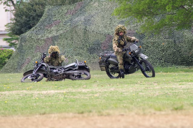 A two-man JGSDF team mans Kawasaki KLX250 dirt bikes in the reconnaissance role during a public demonstration