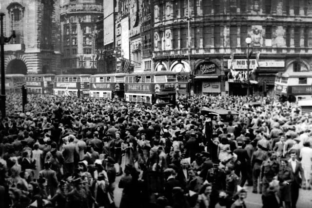 Crowds gathering in celebration at Piccadilly Circus, London during VE Day in 1945