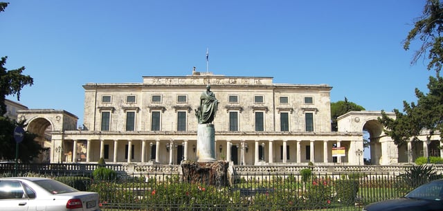 View of the Palace of Saints Michael and George (Palaia Anaktora). The gates of St. Michael and St. George are on the left and right respectively. The gardens are to the right of the arch of St. George. The statue of Sir Frederick Adam, a British governor of Corfu, is at the front.