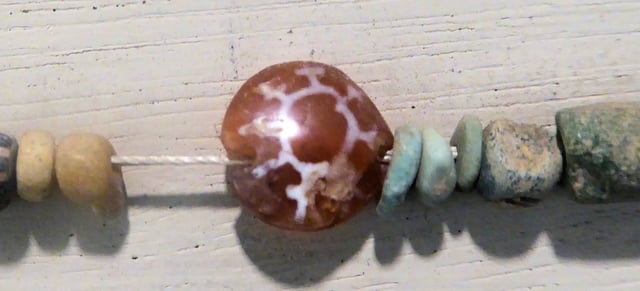 Characteristic Indian etched carnelian bead, found in Ptolemaic Period excavations at Saft el Henna. This is a marker of trade relations with India. Petrie Museum.