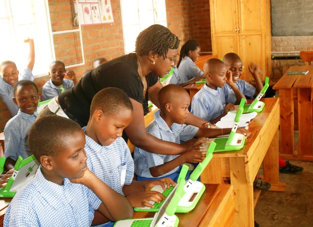 Children in a Rwandan primary school, using laptops supplied by the One Laptop Per Child program