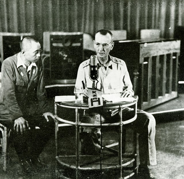 Wainwright ordering the surrender of the Philippines and watched by a Japanese censor