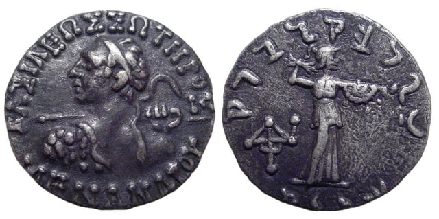 Silver drachm of Menander I, dated circa 160-145 BC. Obverse: ΒΑΣΙΛΕΩΣ ΣΩΤΗΡΟΣ ΜΕΝΑΝΔΡΟΥ ('of King Menander the Saviour'), heroic bust of Menander, viewed from behind, head turned to left; Reverse: Athena standing right, brandishing thunderbolt and holding aegis, Karosthi legend around, monogram in field to left. Reference: Sear 7604.