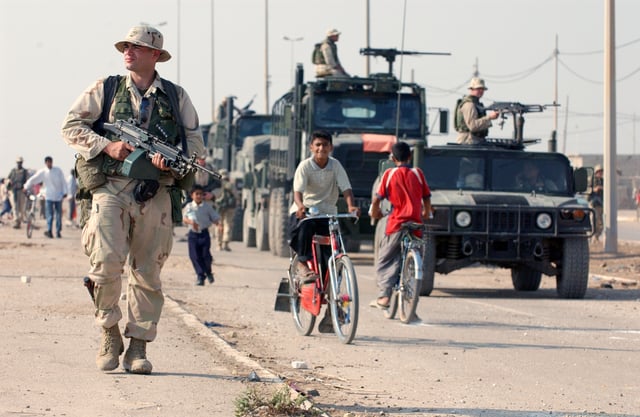 US Marines patrol the streets of Al Faw, October 2003.