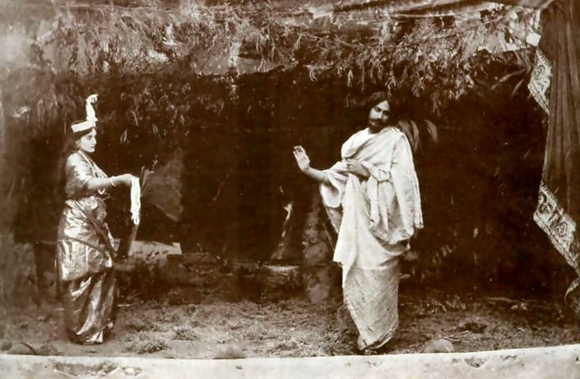 Tagore performing the title role inValmiki Pratibha (1881) with his niece Indira Devi as the goddess Lakshmi.