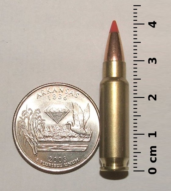 5.7×28mm SS196SR with a quarter and a ruler