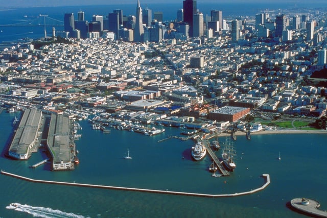 Aerial view of San Francisco, looking south, with Fisherman's Wharf just left of center, directly above a lone sailboat