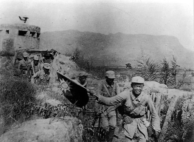 Victorious Chinese Communist soldiers holding the flag of the Republic of China during the Hundred Regiments Offensive