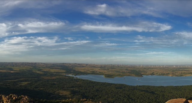 View of Lake Lawtonka, wind turbines, and plains from atop Mount Scott