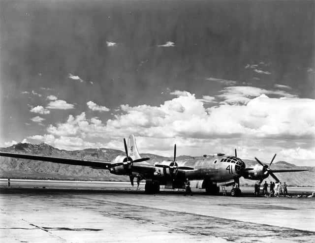 The length of the 141-foot (43 m) wing span of a Boeing B-29 Superfortress based at Davis-Monthan Field is vividly illustrated here with the cloud-topped Santa Catalina Mountains as a contrasting background.