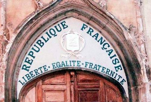 Motto of the French republic on the tympanum of a church in Aups, Var département, which was installed after the 1905 law on the Separation of the State and the Church. Such inscriptions on a church are very rare; this one was restored during the 1989 bicentennial of the French Revolution.