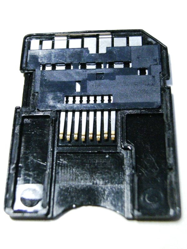 Dismantled microSD to SD adapter showing the passive connection from the microSD card slot on the bottom to the SD pins on the top