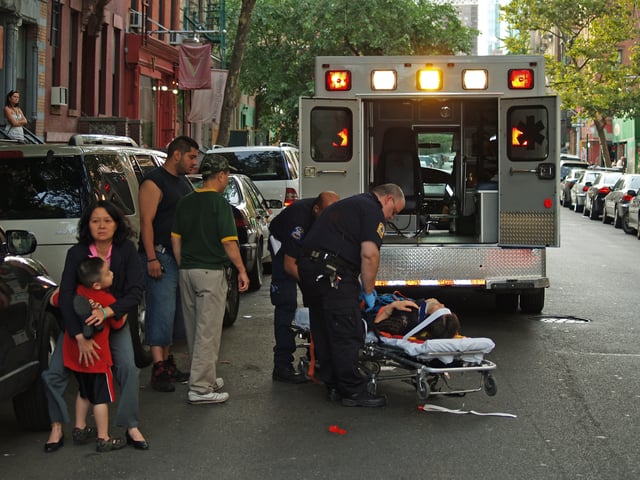 EMTs caring for a collapsed woman in New York