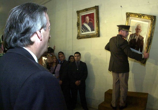 Kirchner oversees the removal of military portraits from the National Reorganization Process at the National Military College.