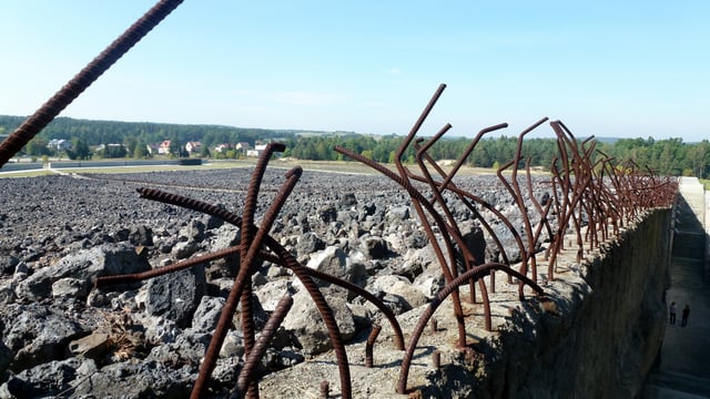 The field of crushed stone serves as grave marker; the entire perimeter contains human ashes mixed with sand.