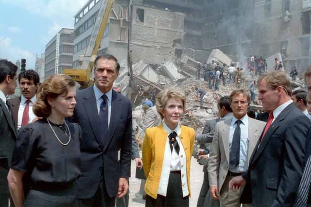 First ladies Paloma Cordero of Mexico (left) and Nancy Reagan of the United States (right) with U.S. Ambassador to Mexico, John Gavin observing the damage done by the 1985 earthquake.