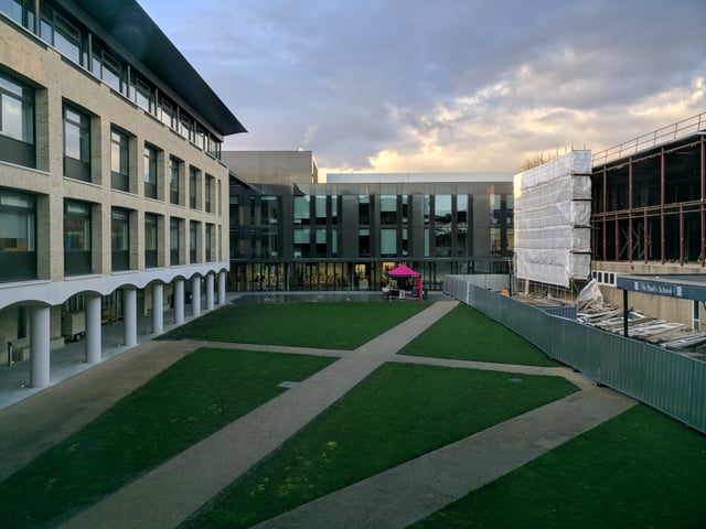 On the left, the new science block is visible; in the centre is the first phase of the new general teaching block (GTB) building; on the right is visible the old half-demolished GTB and the former main entrance.