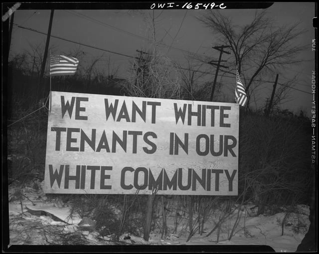 White tenants seeking to prevent blacks from moving into the housing project erected this sign. Detroit, 1942