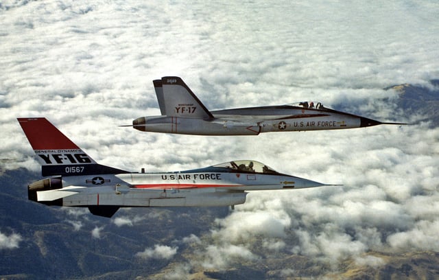 YF-16 and YF-17 in flight during their competitive fly-off, 1974. Over 4,000 production F-16s were built after the competition. The YF-17 was the basis for the highly successful United States Navy F/A-18 Hornet.