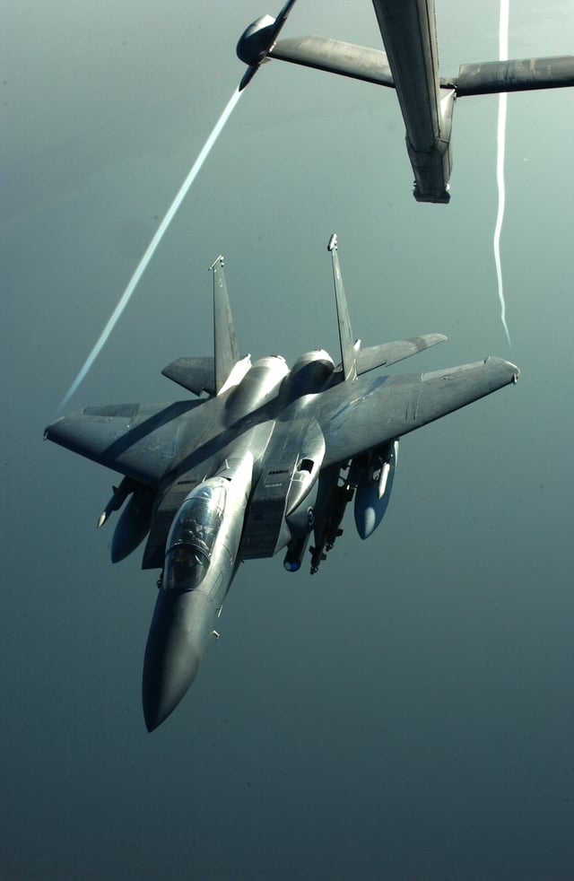 Wingtip vortices are visible trailing from an F-15E as it disengages from midair refueling with a KC-10 during Operation Iraqi Freedom