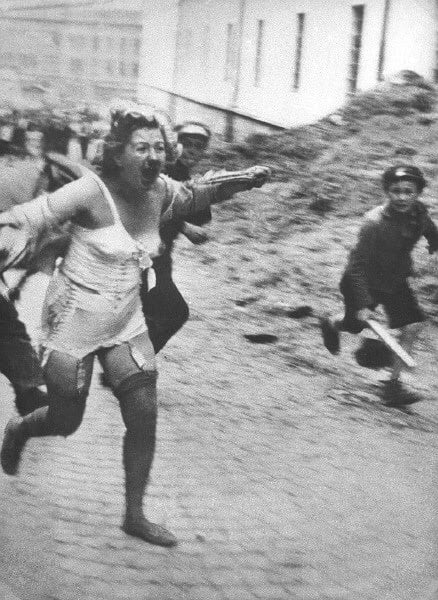 Woman chased by youths armed with clubs during the Lviv pogroms, July 1941, then occupied Poland, now Ukraine