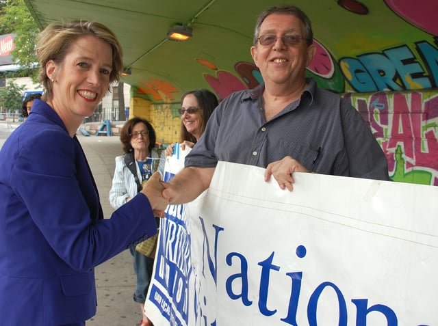 Teachout shaking hands with National Writers Union (UAW Local 1981) president Larry Goldbetter at the "We Will Not Go Back" march and rally held on August 23, 2014.