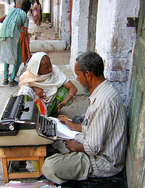 Scribe in India taking instructions from a client