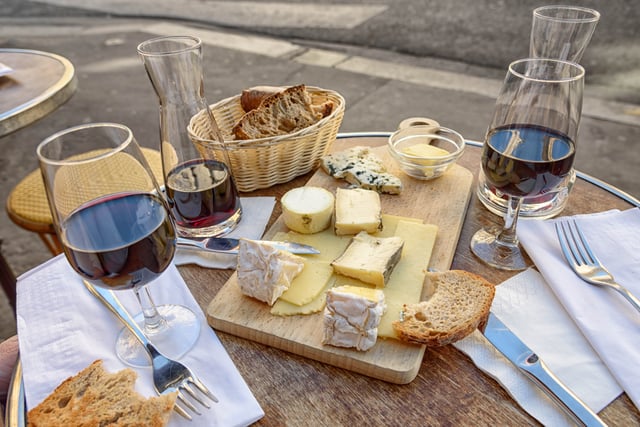 Various cheeses on a cheeseboard served with wine for lunch