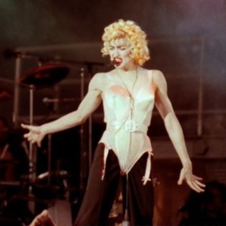 Madonna using the "Madonna mic" during the 1990 Blond Ambition World Tour. She was one of the earliest adopters of hands-free headsets.