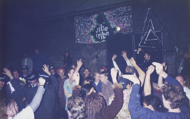 A 1995 Vibe Tribe rave in Erskineville, New South Wales, Australia being broken up by police. MDMA use spread globally along with rave culture.