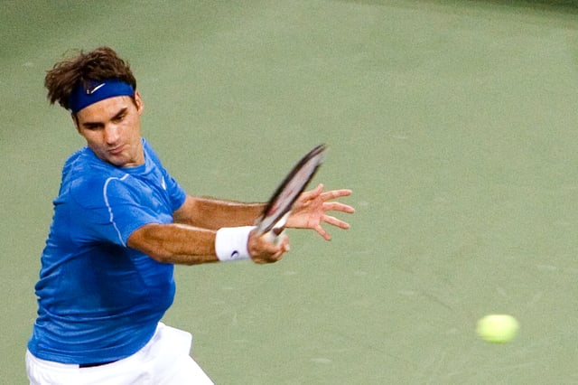 Federer hits a forehand at the 2006 US Open, where he became the first man in history to achieve the Wimbledon-US Open double for three consecutive seasons