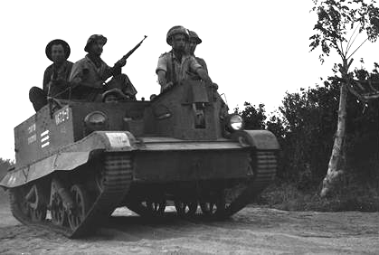 IDF soldiers of the Samson's Foxes unit advance in a captured Egyptian Bren Gun carrier.
