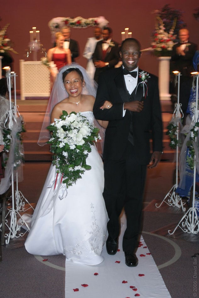A Filipina bride and Nigerian groom walk down the aisle