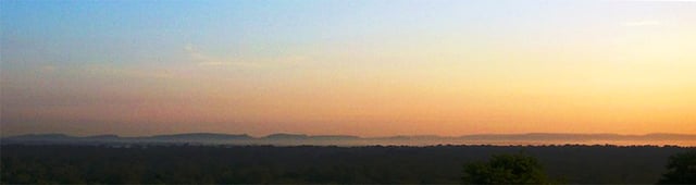 Silhouette of the Dângrêk Mountains, looking north from Cambodia at dawn.