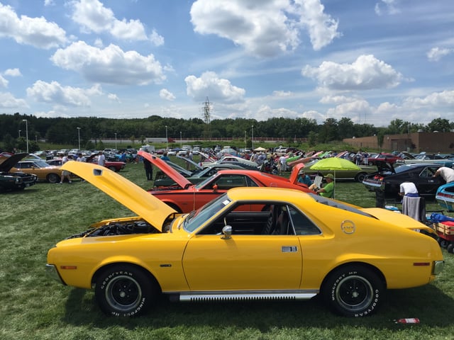 Stock and customized AMXs at an American Motors Owners Association meet