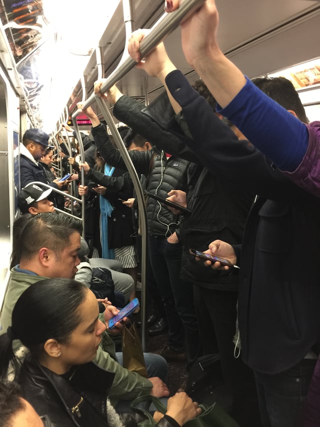 The interior of a Q train during afternoon rush hour