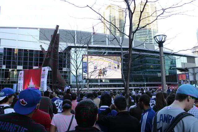 Fans watch the Toronto Maple Leafs play the Boston Bruins in game 2 of the Eastern Conference Quarterfinals in the 2013 Stanley Cup playoffs at Maple Leaf Square, a plaza built by MLSE next to the Scotiabank Arena