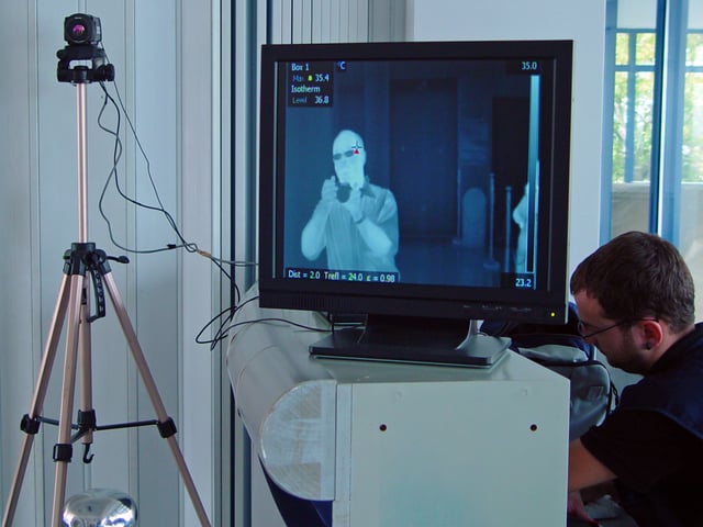 Thermal imaging camera and screen, photographed in an airport terminal in Greece during the 2009 flu pandemic. Thermal imaging can detect elevated body temperature, one of the signs of swine flu.