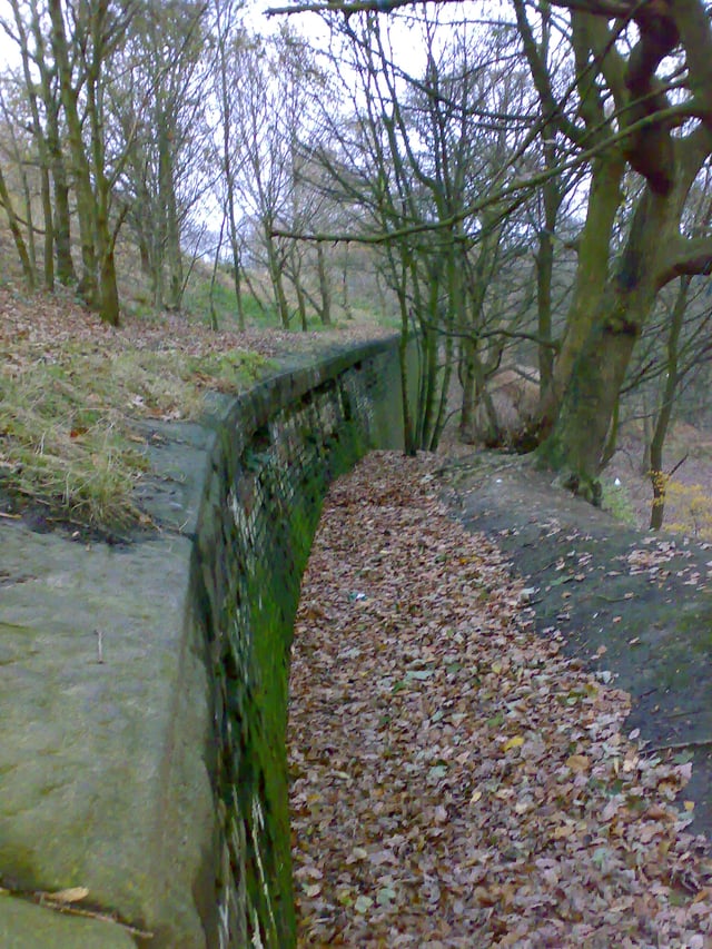 Reinforcements along the Bury arm help keep the canal bank from sliding down the valley.