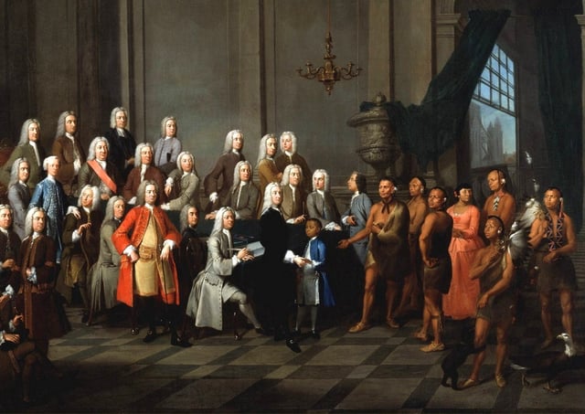 Yamacraw Creek Native Americans meet with the Trustee of the colony of Georgia in England, July 1734. The painting shows a Native American boy (in a blue coat) and woman (in a red dress) in European clothing.