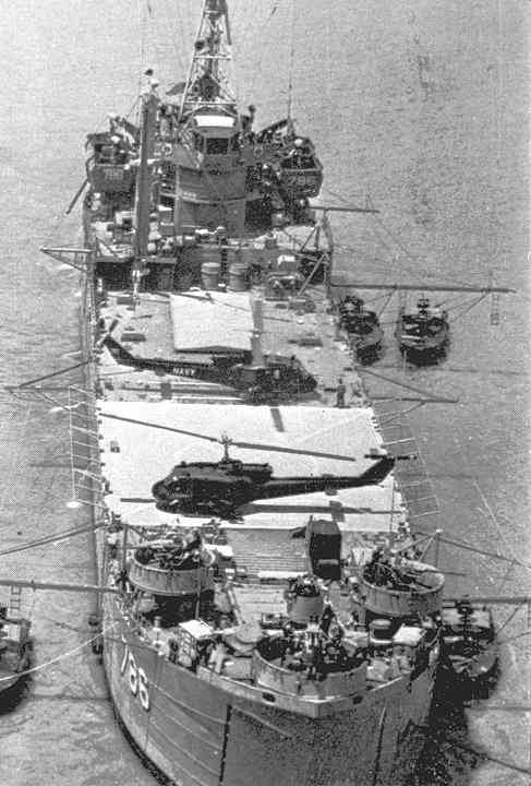 Two UH-1B Huey gunships from HAL-3 "Seawolf" sit on the deck of USS Garrett County in Mekong Delta, South Vietnam.