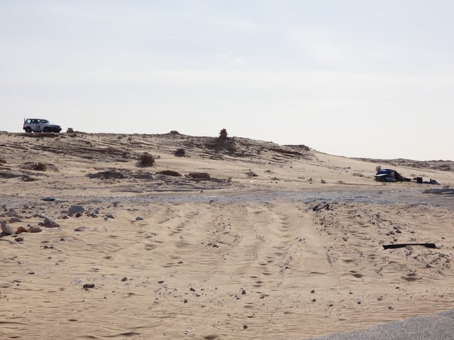 A MINURSO car (left), and a post of the Polisario Front (right) in 2017 in southern Western Sahara