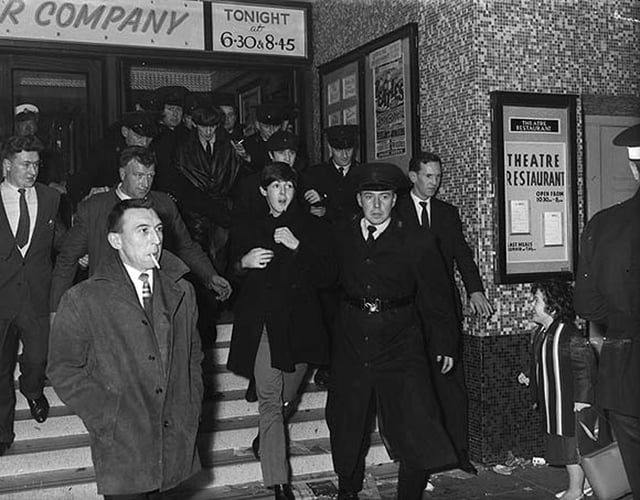 The Beatles emerging from the Ritz Cinema, Belfast following their concert, 8 November 1963.