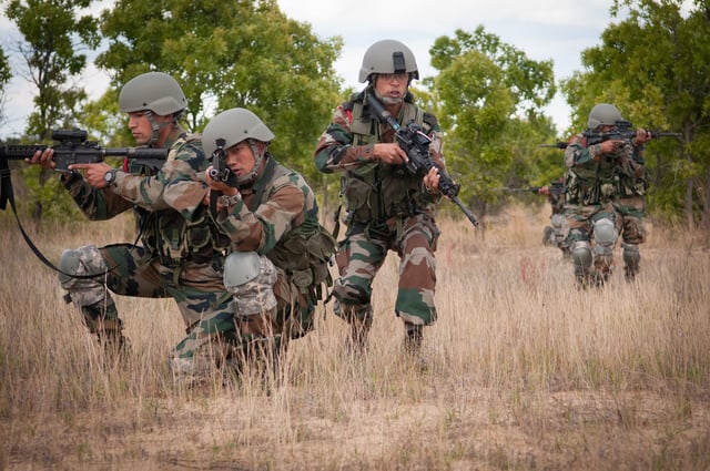 Indian Army soldiers move in to position while demonstrating a platoon level ambush to U.S Army paratroopers.